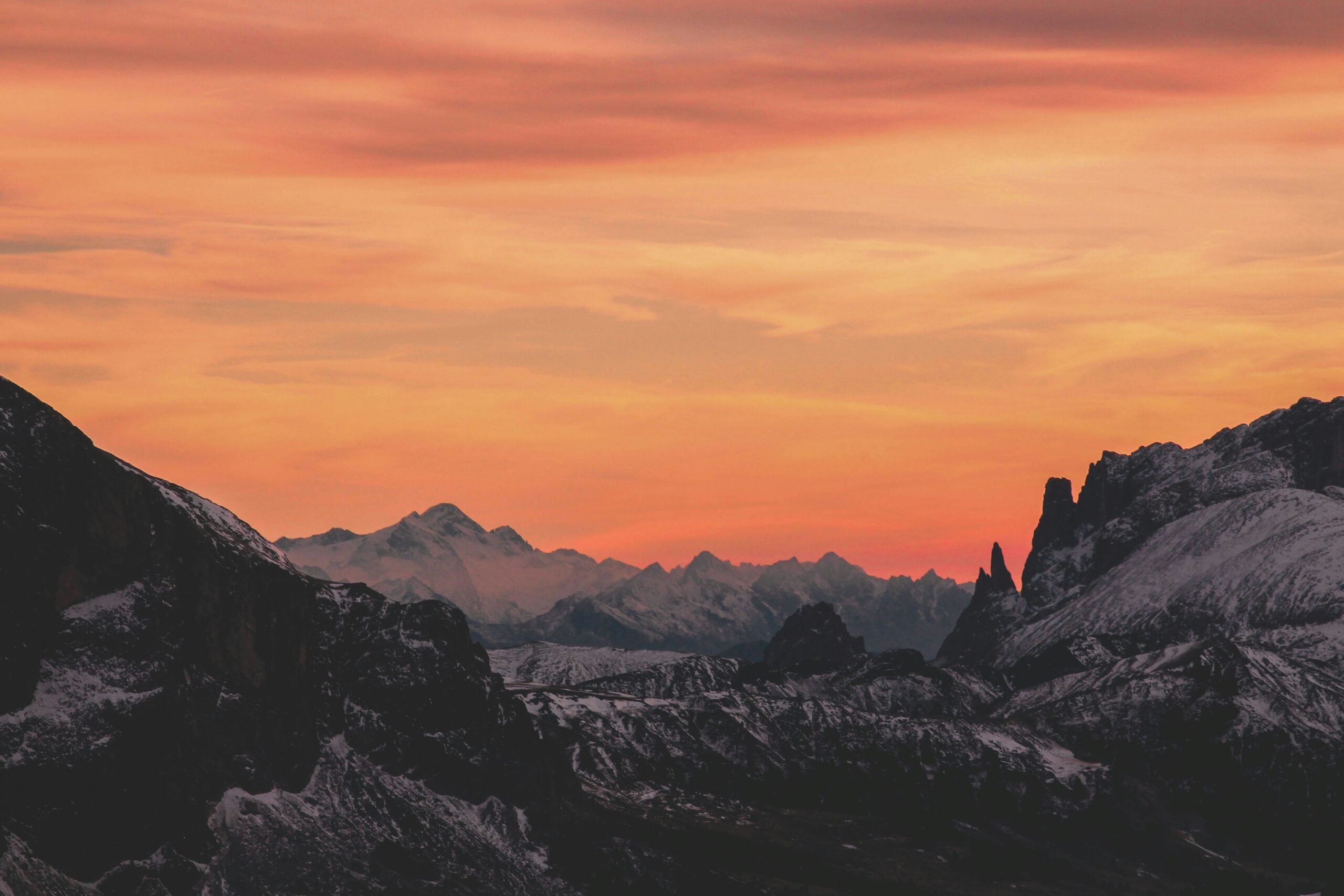 Mountain landscape at sunset with vibrant sky.