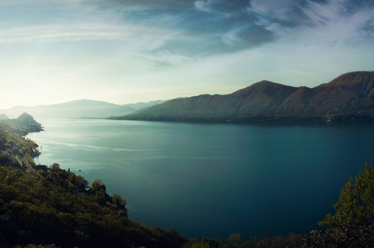 Serene lake view with distant mountains and trees