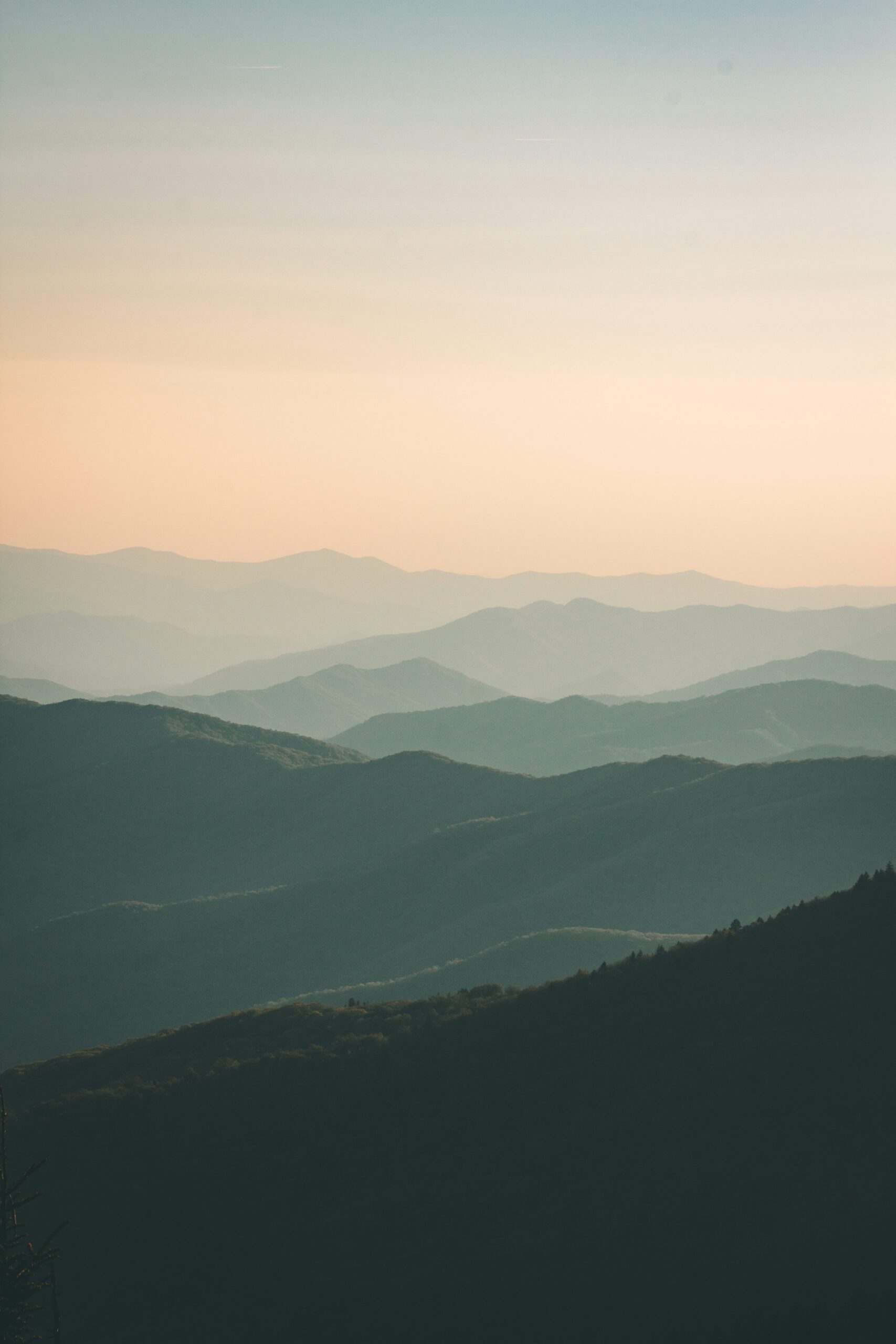 Mountains under mist at daytime with a hazy sky