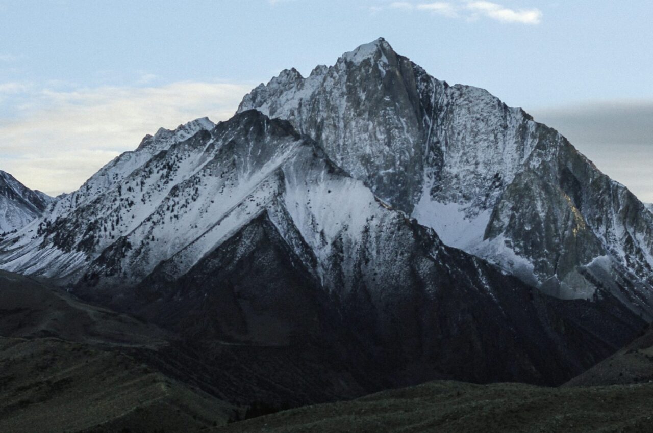 Snow-capped mountain with rugged peaks under a clear sky