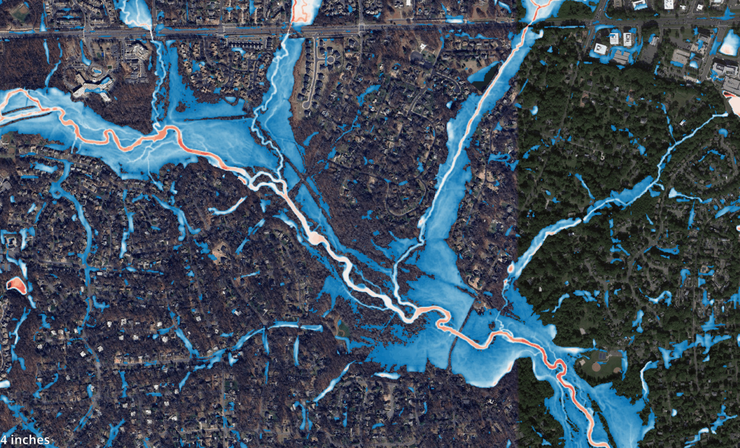 Aerial map showing flood risk areas highlighted in blue tones across a residential and wooded region