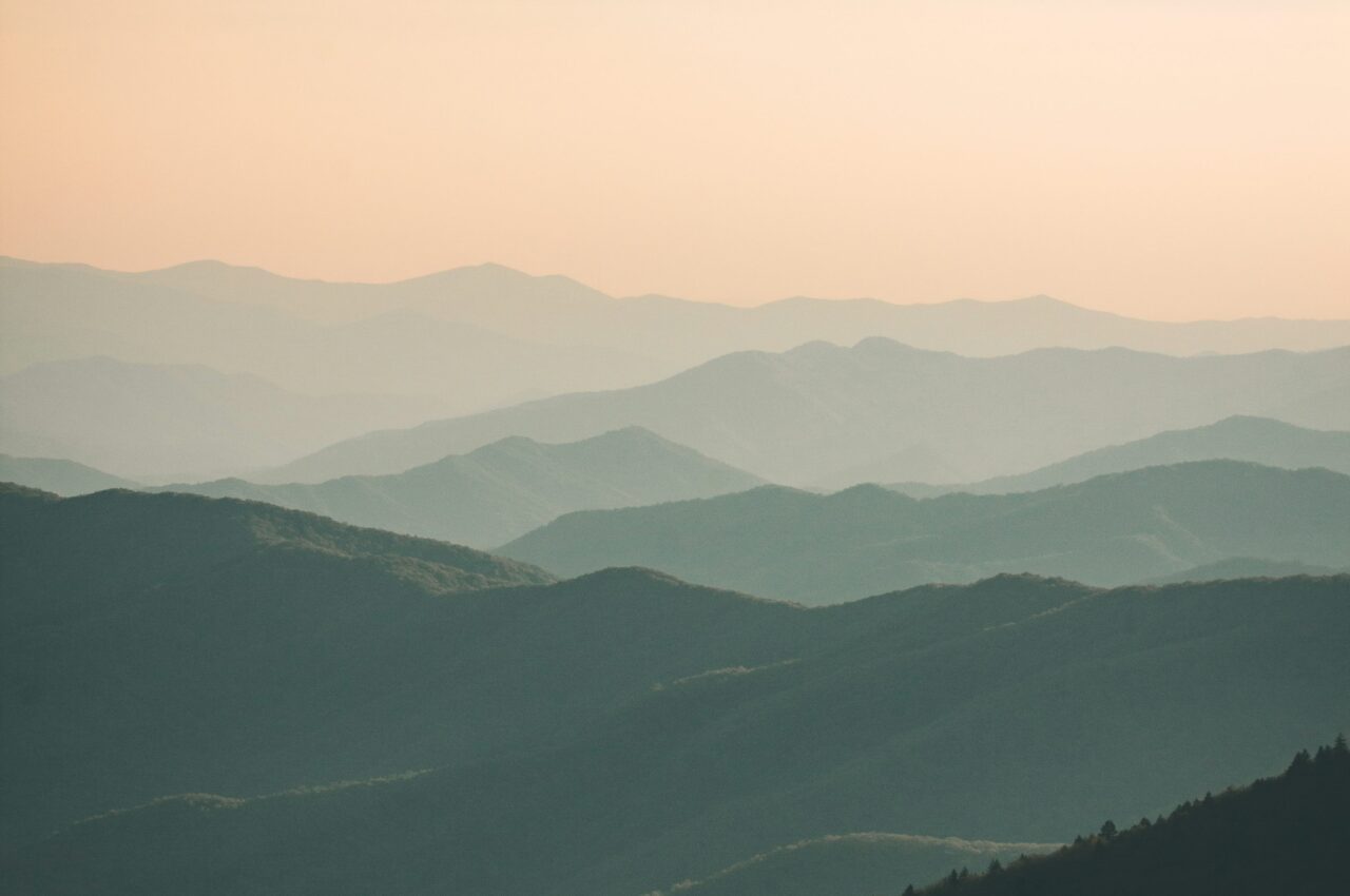 Mountains under mist at daytime with a hazy sky