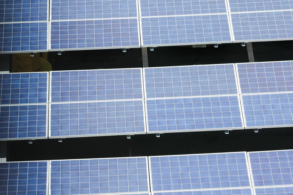Transitioning to renewable energy systems, such as solar, wind, or geothermal, significantly reduces carbon emissions from buildings and infrastructure.