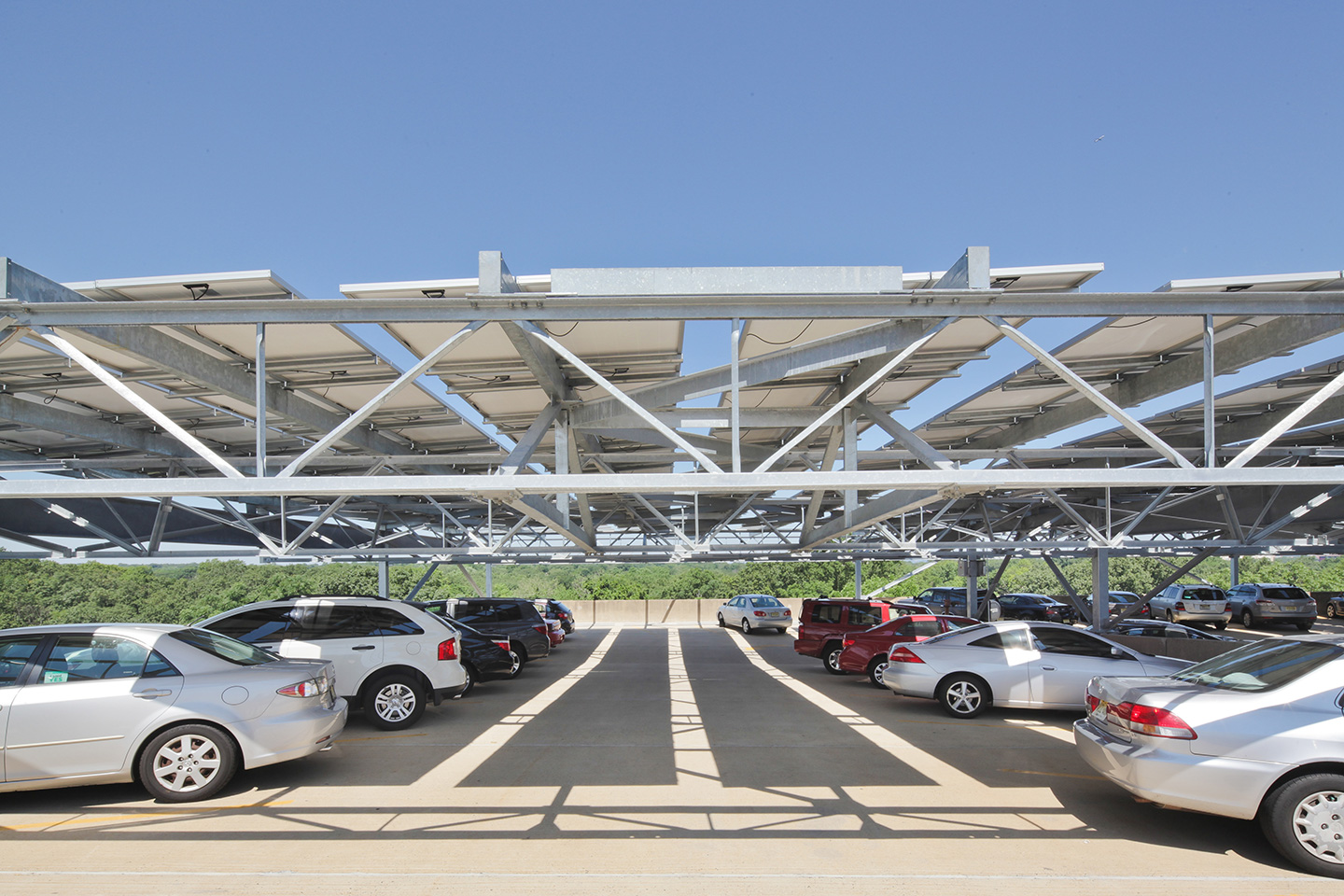 Canopy solar systems serve a dual purpose of collecting solar power while also providing shade and weather protection for the cars beneath.