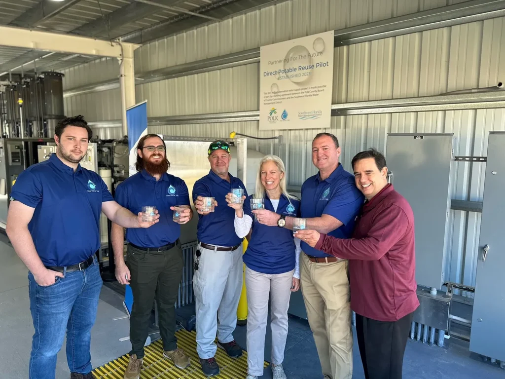 Dewberry staff Robert Beltran, Matt O'Connor, Devon Higgins, and Andrew Starling celebrate the pilot facility’s completion with Polk County Utilities staff Buddy Gary and Tania McMillan