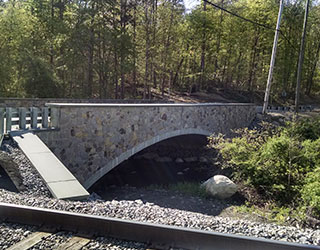 The new Cozy Lake Road bridge includes stone facing of exposed concrete surfaces. Photo courtesy of Dewberry.