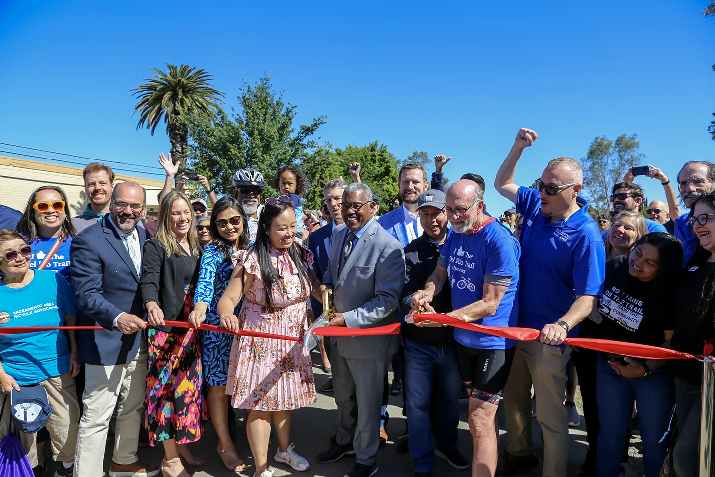 City of Sacramento staff celebrate the ribbon cutting with residents.