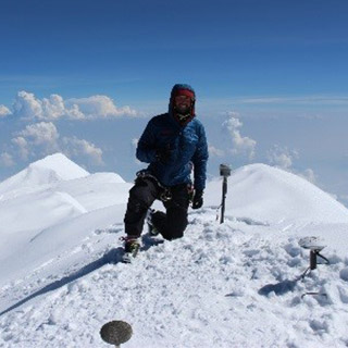 Blaine Horner, survey party chief with CompassData, a Dewberry subcontractor, places GPS antennae at the summit of Denali. The four-person survey crew  reached the summit on June 24.