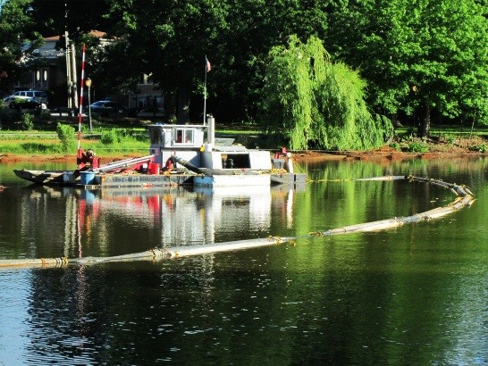 Non-propelled cutter suction dredger in operation within Springfield Lake.