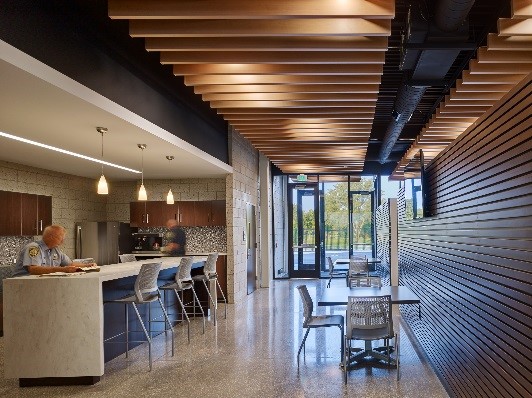 The primary staff entry opens to an inviting break area with warm natural finishes.