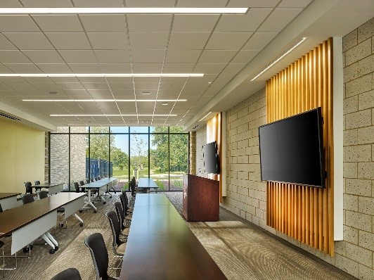 The first-floor community room serves as a meeting space for local organizations with direct views of a neighborhood park.