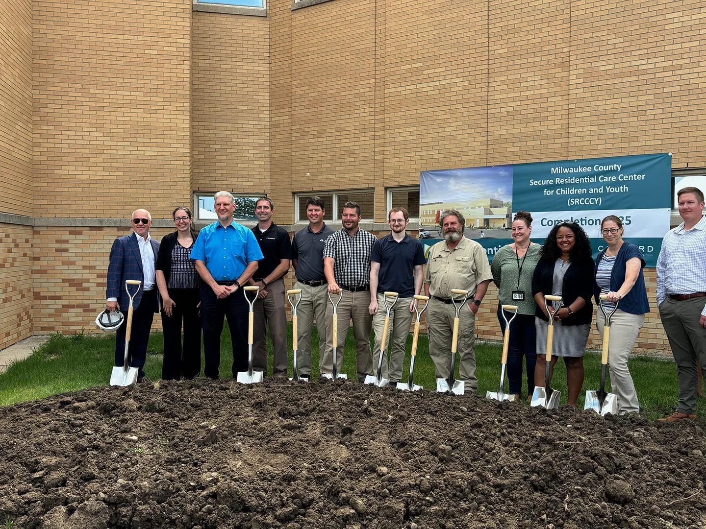 Representatives from Milwaukee County, Continuum Architects   Planners, Bloom Companies, K. Singh & Associates, The Concord Group, and Dewberry break ground on the new facility. Photo courtesy of Dewberry.