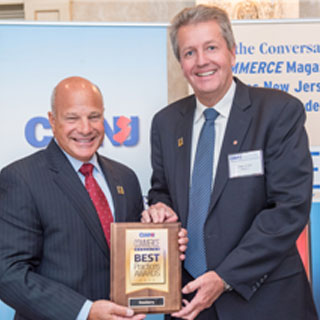 Craig Johnson (right), Dewberry President of the Northeast, accepts the award on behalf of Dewberry