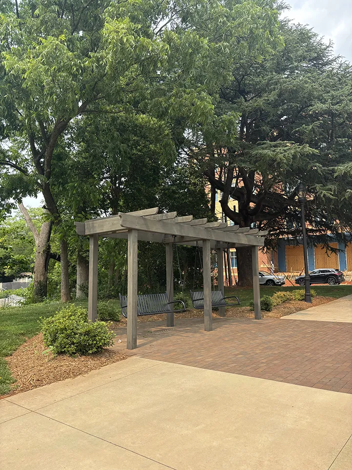 Shaded areas with trellis swings invite conversation and connection.