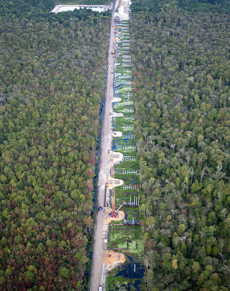 In response to varying depths of load-bearing geotechnical materials, we ordered piles of different lengths with spliced ends that allowed us to attach and drive them 60 to 180 feet underground.