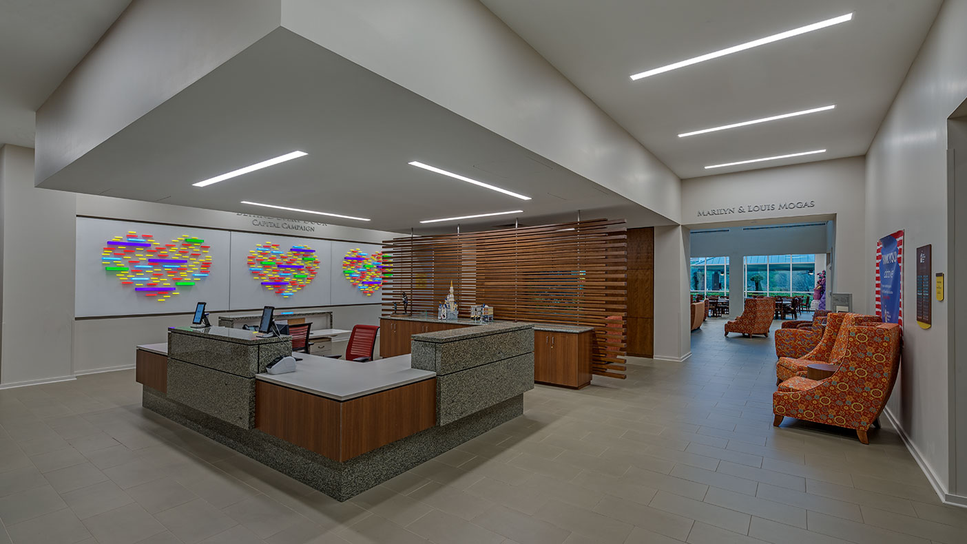 We designed the original three-story, 54,000-square-foot facility known as the Holcombe House, with 50 guest rooms, family-friendly kitchen, dining area, and common areas, completed in 1997.