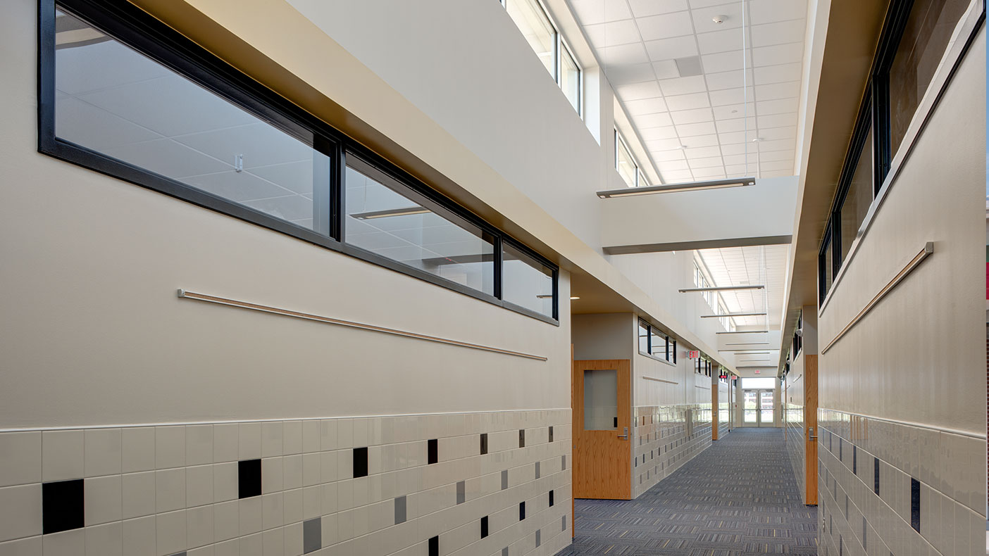 The high corridor design allows heat to rise and lets natural light into the space.