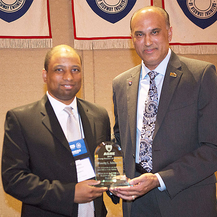 Tim Belcher accepts the national 2015 ASHE Young Member of the Year Award from past President Samir Mody at the national convention in Baltimore, Maryland.