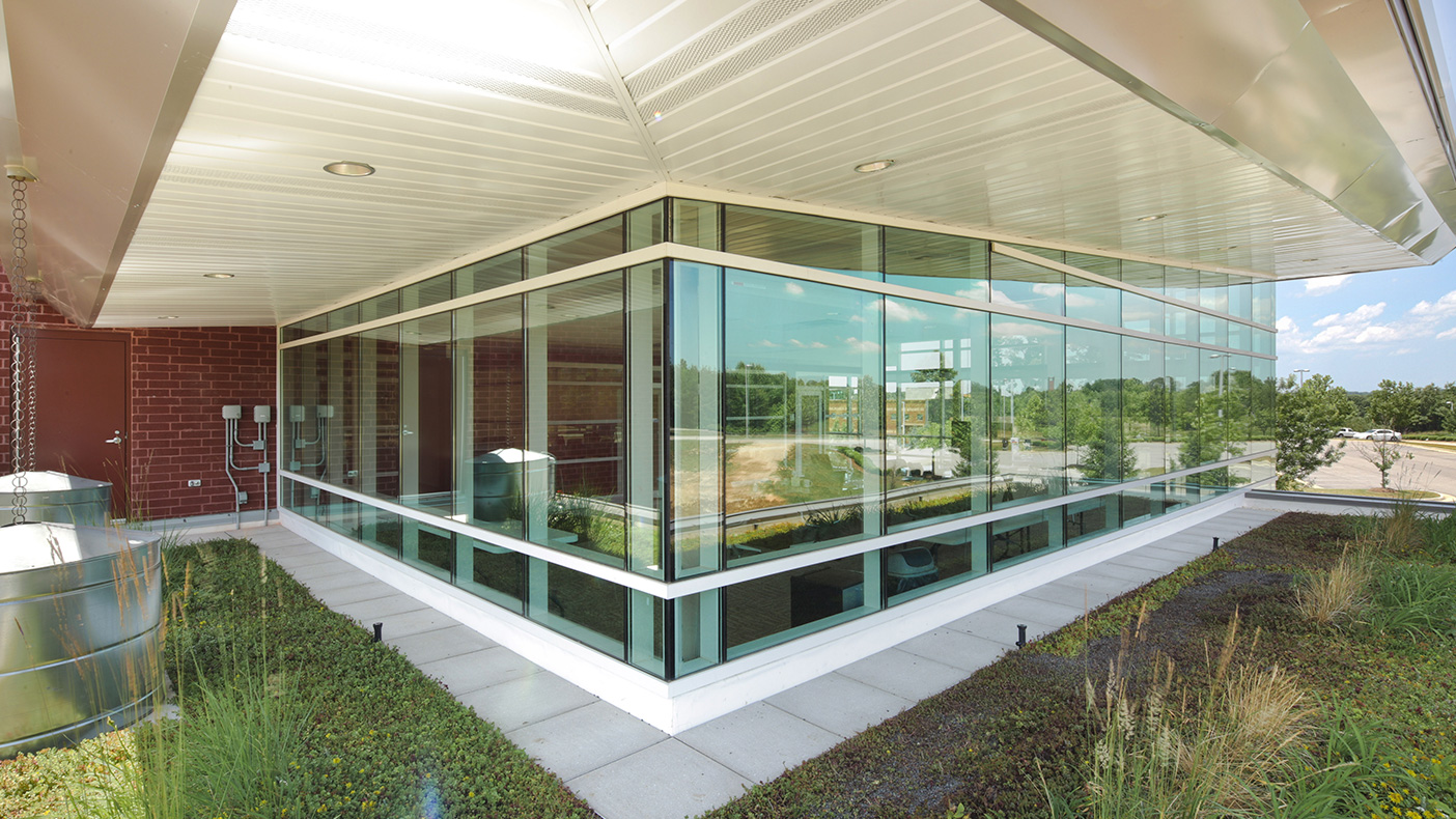 To allow as much natural light into the building as possible, we designed the facility to include six-foot overhangs (adjusted to the angle of the single pitched roof), appropriately spaced sunshades, and a depth-adjusted window wall system.